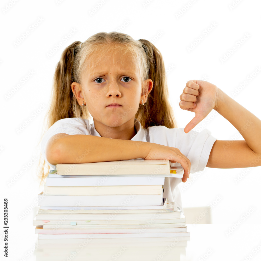 Stressed schoolgirl overwhelmed with too much homework hatting studying and school Stressed schoolgirl overwhelmed with too much homework hatting studying and school