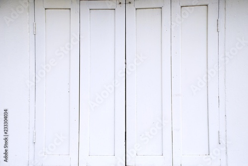 Old white wooden window on white wall.
