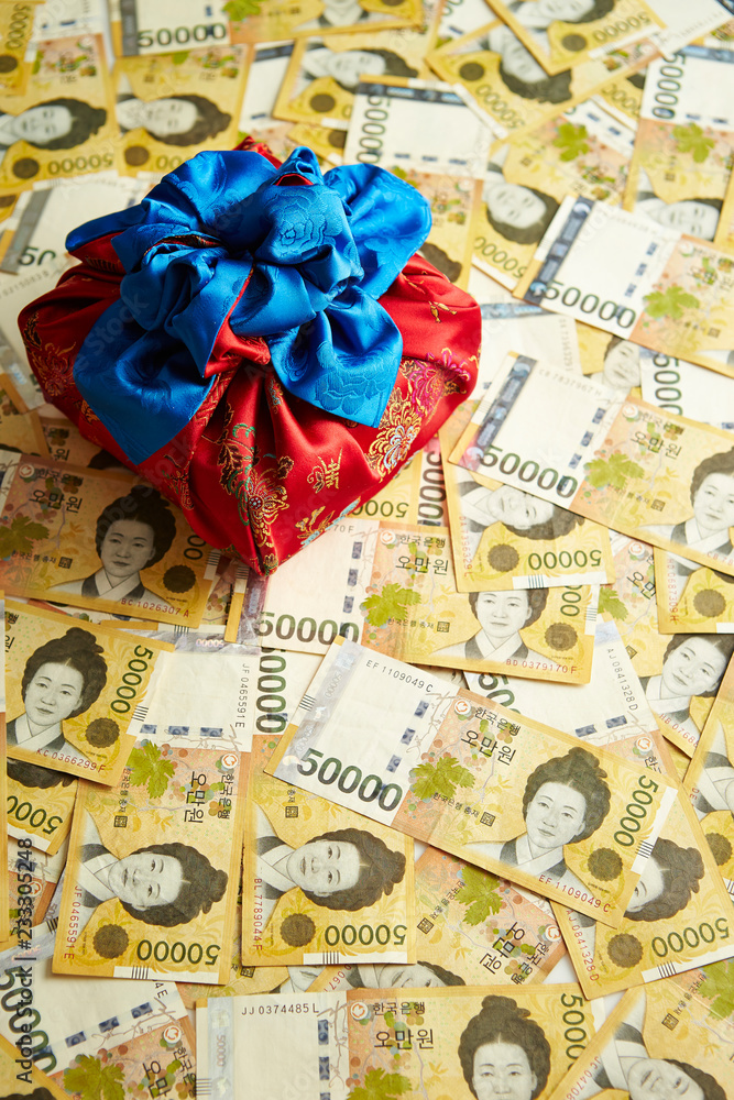 Traditional Korean wrapping cloth with Korean won banknotes background Traditional Korean wrapping cloth with Korean won banknotes background