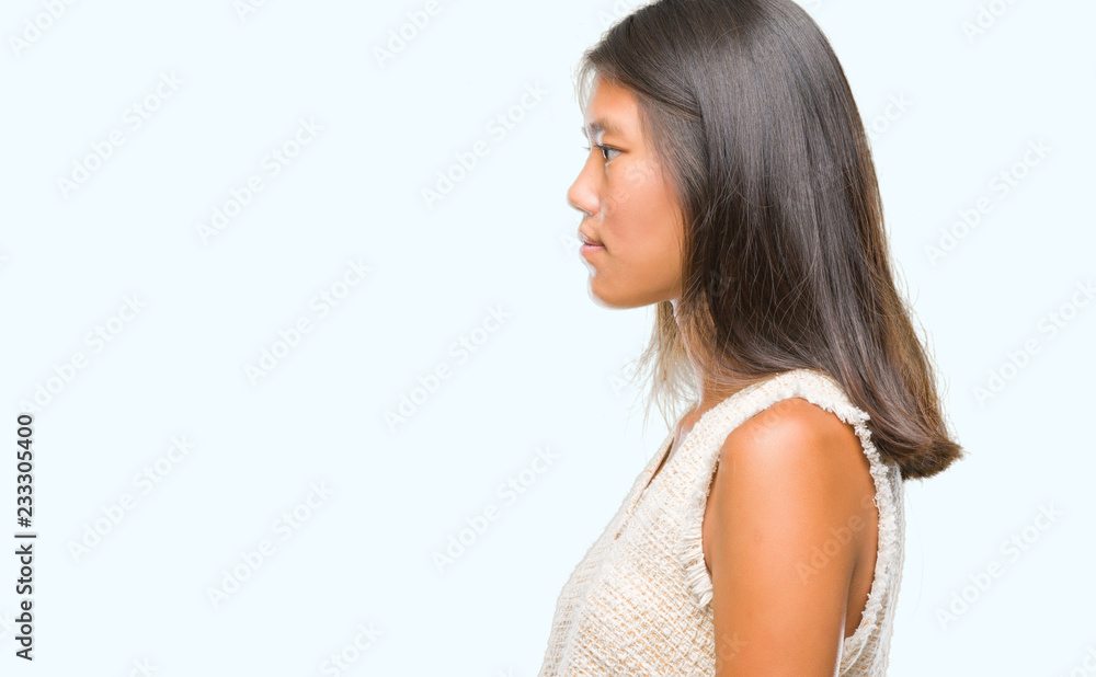 Young asian woman over isolated background looking to side, relax profile pose with natural face with confident smile. Young asian woman over isolated background looking to side, relax profile pose with natural face with confident smile.