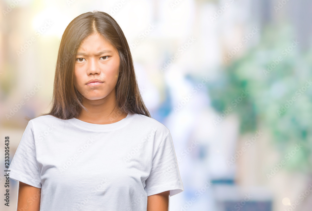 Young asian woman over isolated background skeptic and nervous, frowning upset because of problem. Negative person. Young asian woman over isolated background skeptic and nervous, frowning upset because of problem. Negative person.
