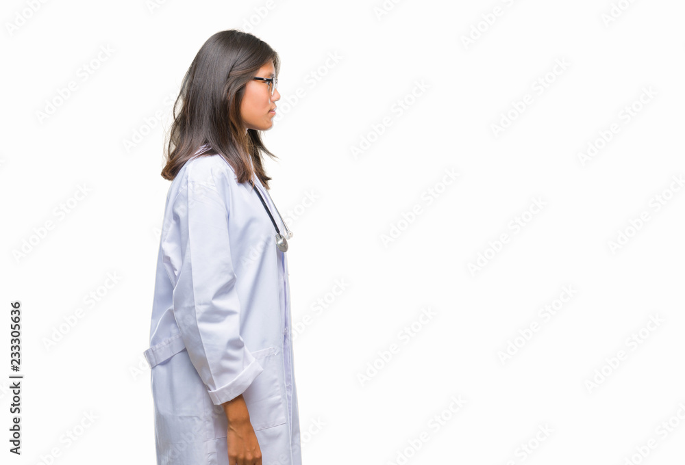 Young asian doctor woman over isolated background looking to side, relax profile pose with natural face with confident smile. Young asian doctor woman over isolated background looking to side, relax profile pose with natural face with confident smile.