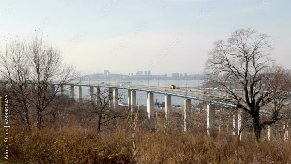 The bridge from Cape Churkin to Russky Island through the Bosphorus East in the Far Eastern city of Vladivostok. The movement of cars on the mainland of the Russian or Russky Bridge. The bridge from Cape Churkin to Russky Island through the Bosphorus East in the Far Eastern city of Vladivostok. The movement of cars on the mainland of the Russian or Russky Bridge.