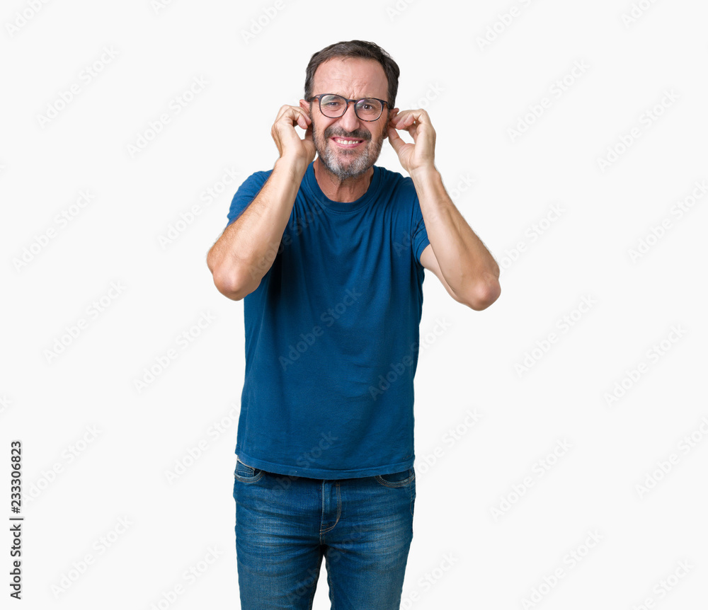 Fototapeta premium Handsome middle age hoary senior man wearin glasses over isolated background covering ears with fingers with annoyed expression for the noise of loud music. Deaf concept.