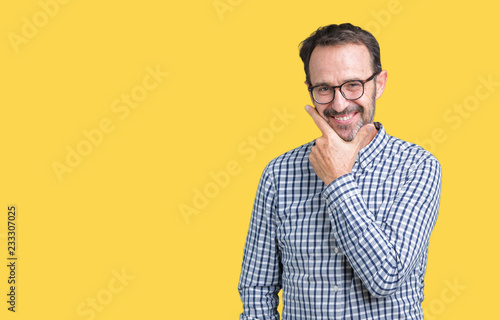 Handsome middle age elegant senior business man wearing glasses over isolated background looking confident at the camera with smile with crossed arms and hand raised on chin. Thinking positive.