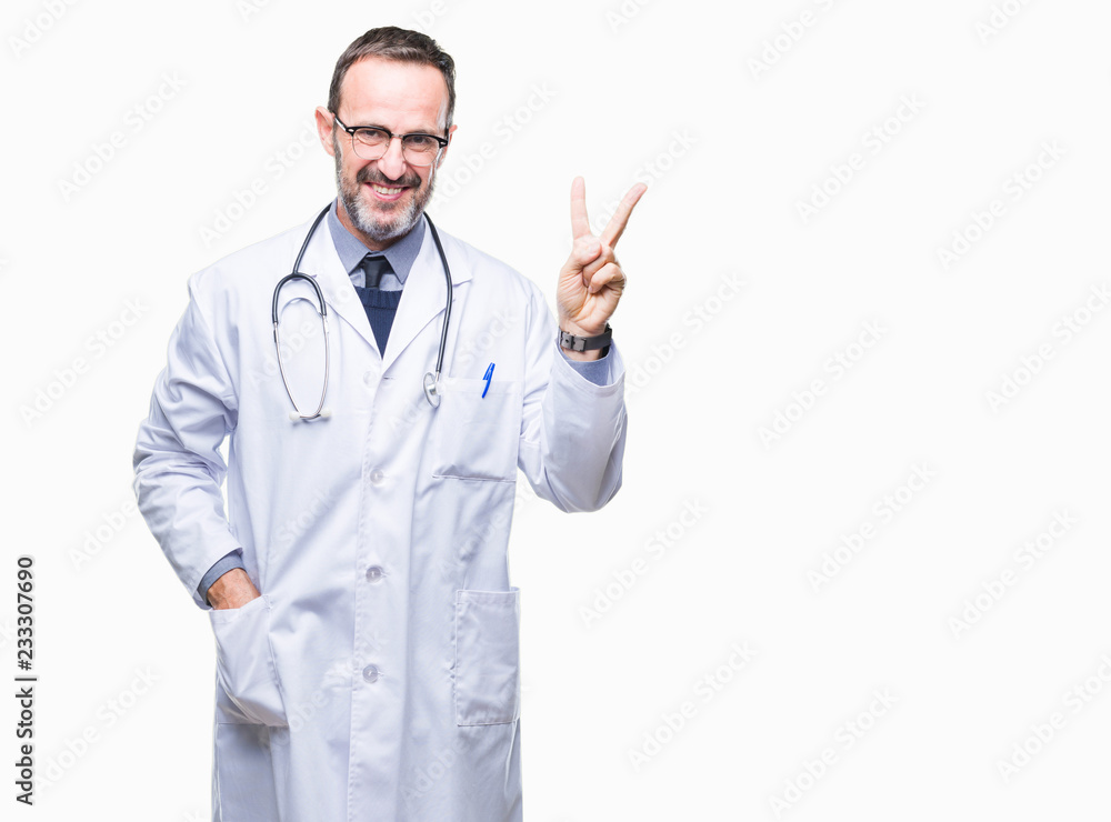 Middle age senior hoary doctor man wearing medical uniform isolated background smiling with happy face winking at the camera doing victory sign. Number two. Middle age senior hoary doctor man wearing medical uniform isolated background smiling with happy face winking at the camera doing victory sign. Number two.