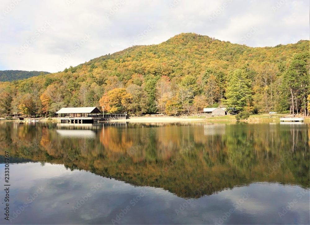 Fantastic view of colorful mountain with reflection in the lake at Vogel State park with blue sky white clouds on the background, Autumn in GA USA.