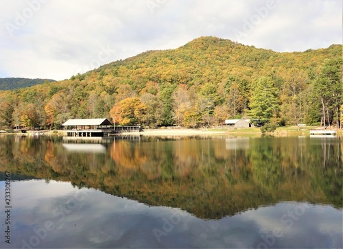 Fantastic view of colorful mountain with reflection in the lake at Vogel State park with blue sky white clouds on the background, Autumn in GA USA.