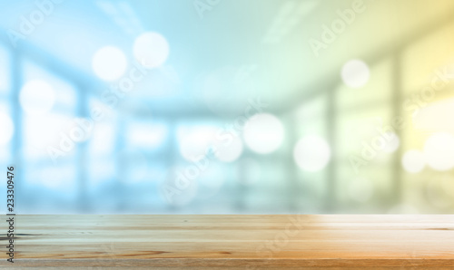 Wooden desk with Blurred of interior office room with city building background