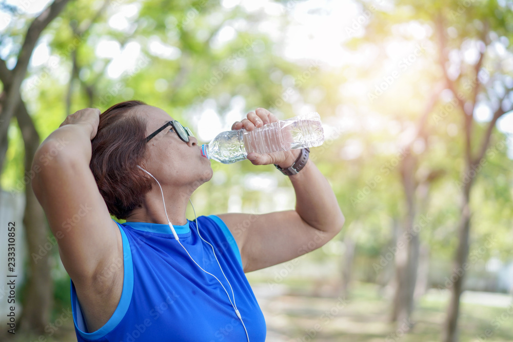 Senior asian woman drinking water bottle after work out exercising, Athletic senior together outdoor Senior asian woman drinking water bottle after work out exercising, Athletic senior together outdoor