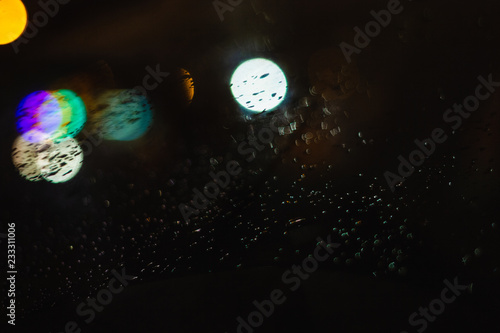 Night rain drops on the surface of the car, abstract background