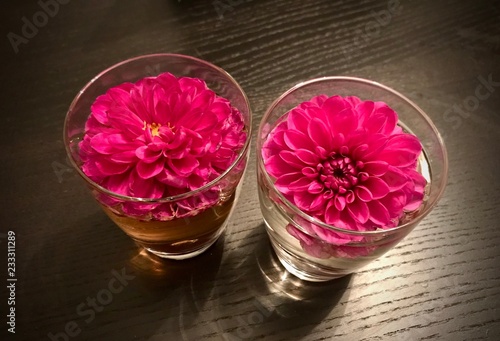 Dalia flowers floating in a water glass