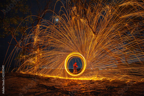 long exposure speed motion abstract of steel wool at twight beside mangrove forest