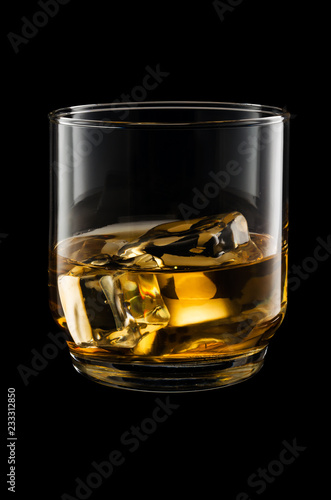 Glass of whisky isolated on black background