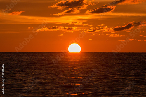 Horizon view angle of Sunset sun down moment at beach © alenthien
