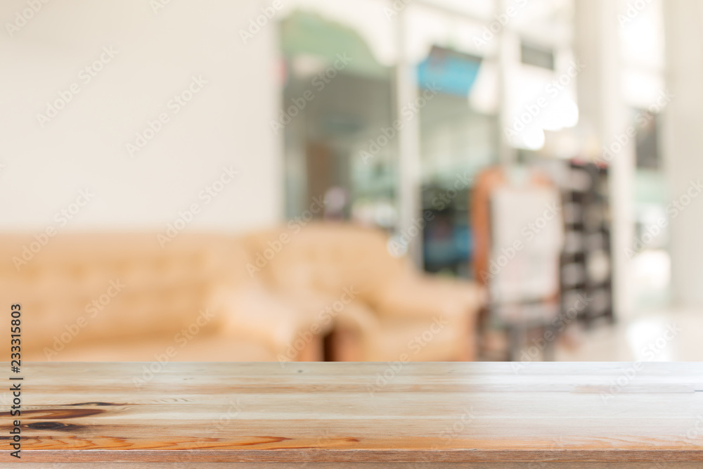 Wooden desk with Abstract blurred livingroom decoration interior for background Wooden desk with Abstract blurred livingroom decoration interior for background