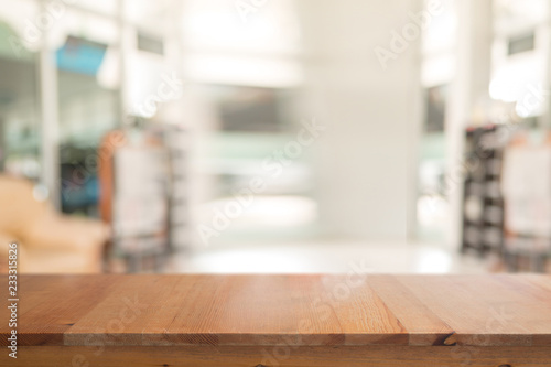 Wooden desk with Abstract blurred livingroom decoration interior for background