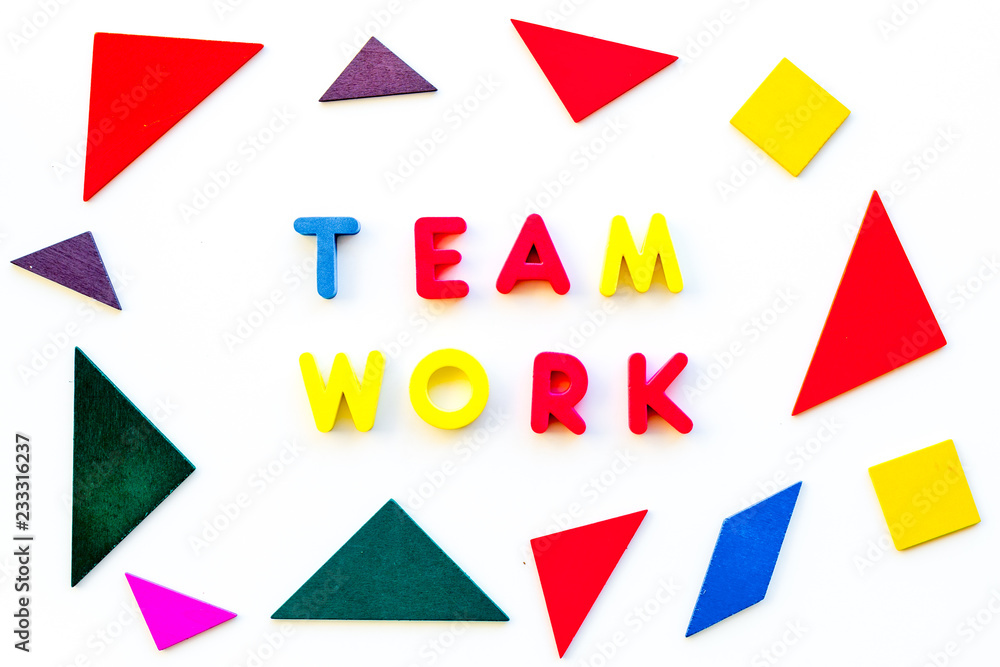 Teamwork concept. Teamwork techniques for students. Text teamwork lined with colored letters in abstract colored frame on white background top view Teamwork concept. Teamwork techniques for students. Text teamwork lined with colored letters in abstract colored frame on white background top view