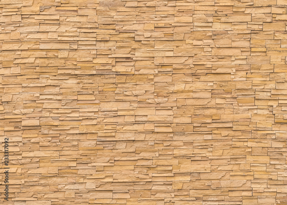 Rock stone brick tile wall aged texture detailed pattern background in dark cream beige brown color Rock stone brick tile wall aged texture detailed pattern background in dark cream beige brown color