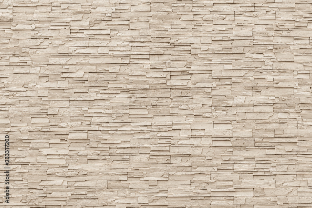 Rock stone brick tile wall aged texture detailed pattern background in yellow cream beige color Rock stone brick tile wall aged texture detailed pattern background in yellow cream beige color
