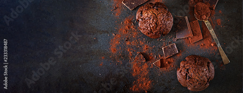 Chocolate muffin on dark background. Top view. Banner. Flat lay
