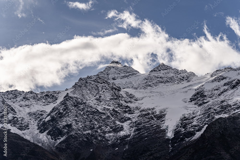 Amazing landscape of great caucasian mountain range. Amazing nature and ecology concept of big mountains with high rocks and blue cloudy sky in sunny day. Russia, Elbrus region.