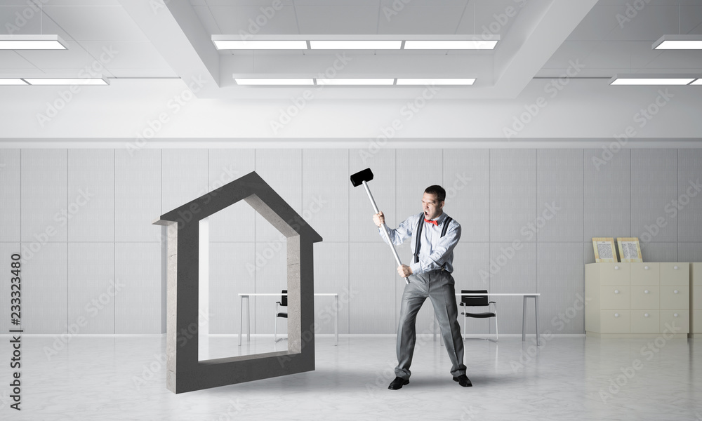 Fototapeta premium Stone home silhouette as symbol for real estate insurance crashed with man
