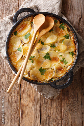 Janssonin Kiusaus four Ingredient Finnish Potato Bake closeup on the table. Vertical top view photo