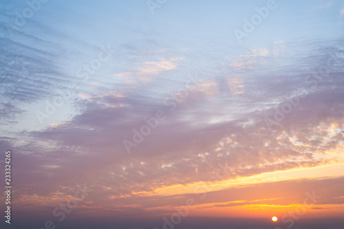 Beautiful orange blue sky with clouds at sunrise © Dina Photo Stories
