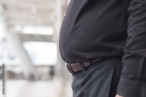 fat man belly. close up shot of fat, obese, overweight dad bod stomach. southeast asian man model photo