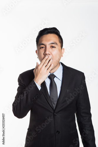 Man in suit yawning