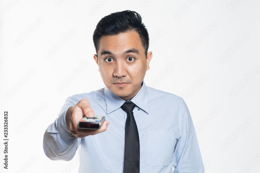 Man in office wear pointing a remote control Man in office wear pointing a remote control