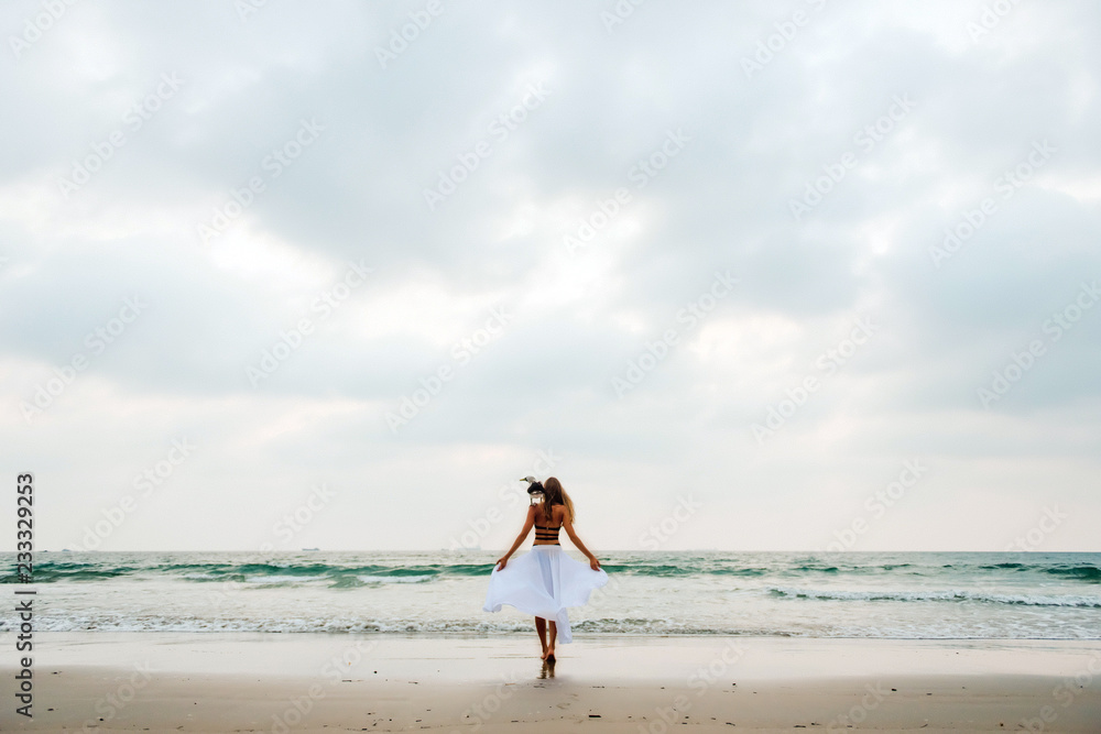 A beautiful young blonde enjoying life on the beach, with a wild albatross on her shoulder. A beautiful young blonde enjoying life on the beach, with a wild albatross on her shoulder.