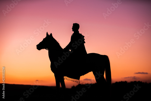 Horses and Men Silhouette at Sunset on a High Mountain © Pongvit