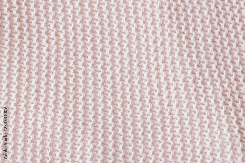 Pink texture of the knitted fabric. Vertical view.