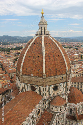 The cathedral on the background of the city./A large cathedral with a beautiful dome rises above the panorama of the city.