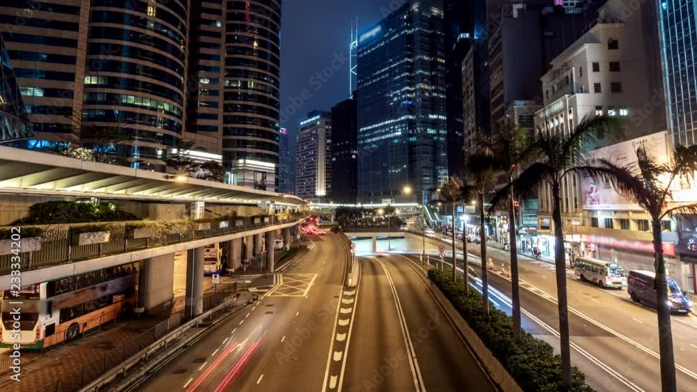 Hong Kong city traffic after sunset. Illuminated street and skyscrapers in Hong Kong at night Hong Kong city traffic after sunset. Illuminated street and skyscrapers in Hong Kong at night