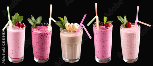 A set of milkshakes and smoothies in glasses. On a black background