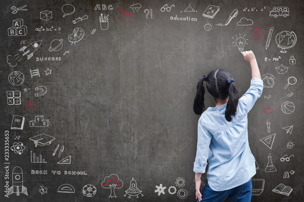 Obraz na plátně Elementary school kid student drawing doodle on black chalkboard with child's im