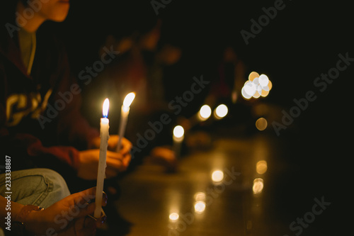 Photography soft focus of people lighting candle vigil in darkness seeking hope, worship, pr