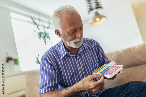 Senior man taking pills at home