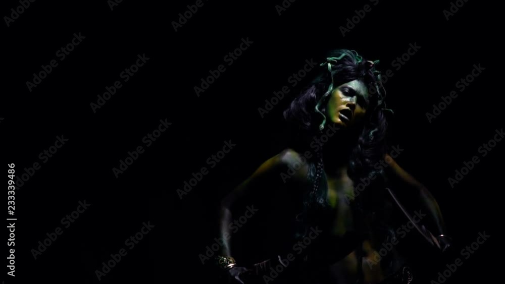 Medusa standing in the dark and swinging her blades Medusa standing in the dark and swinging her blades