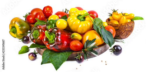 Assorted tomatoes and vegetables isolated on white background. Photo for your design.
