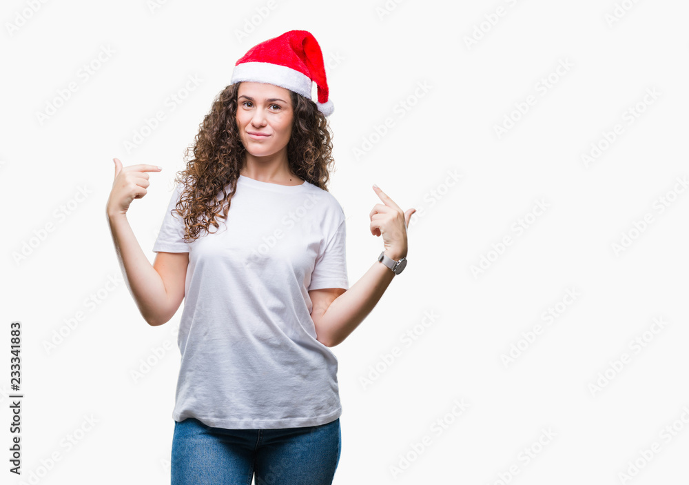 Young brunette girl wearing christmas hat over isolated background looking confident with smile on face, pointing oneself with fingers proud and happy. Young brunette girl wearing christmas hat over isolated background looking confident with smile on face, pointing oneself with fingers proud and happy.