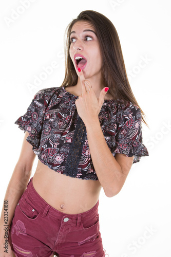 beautiful pretty young teenage woman with a surprised head and finger in front of the mouth