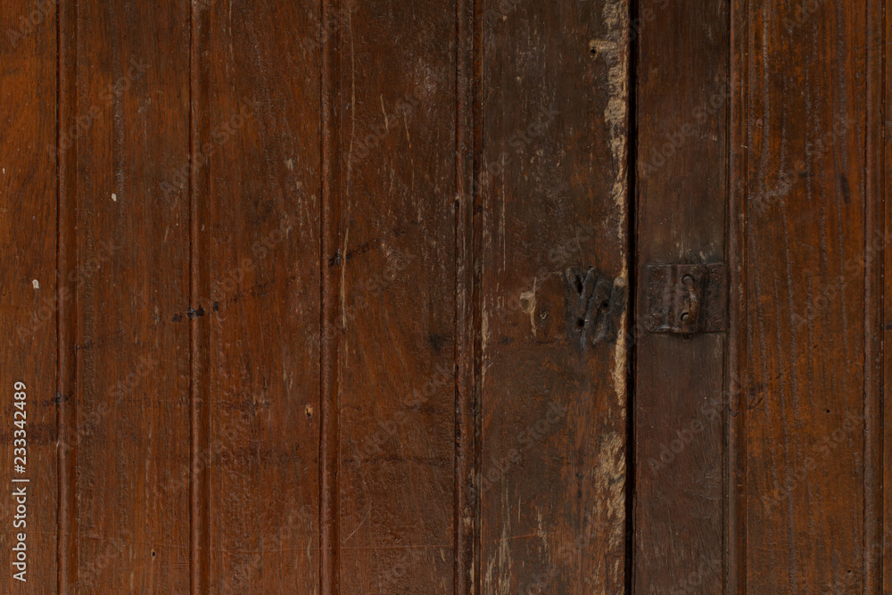 Metal old rusty handle on wooden door Metal old rusty handle on wooden door