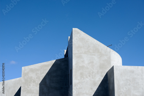 Detail of geometric shapes and clean lines of a modern Australian concrete domestic house shown by the play of sun and shadow. 