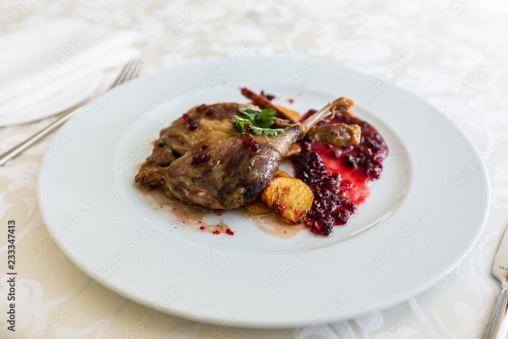 Duck leg confit with mountain cranberries sauce and pear chutney Duck leg confit with mountain cranberries sauce and pear chutney