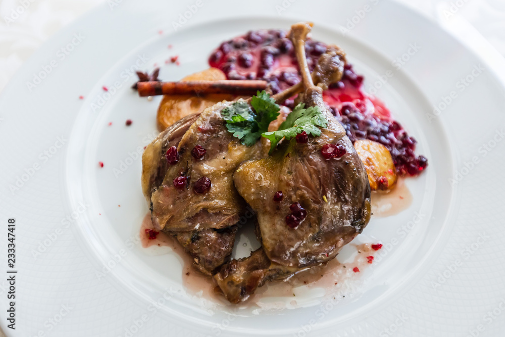 Duck leg confit with mountain cranberries sauce and pear chutney Duck leg confit with mountain cranberries sauce and pear chutney