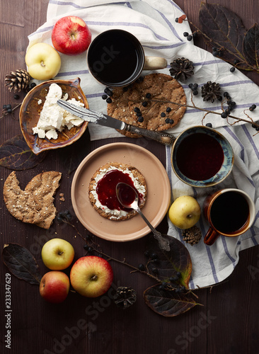 Swedish rye crispbread with cream cheese and raspberry jam. Autumn and winter breakfast concept.